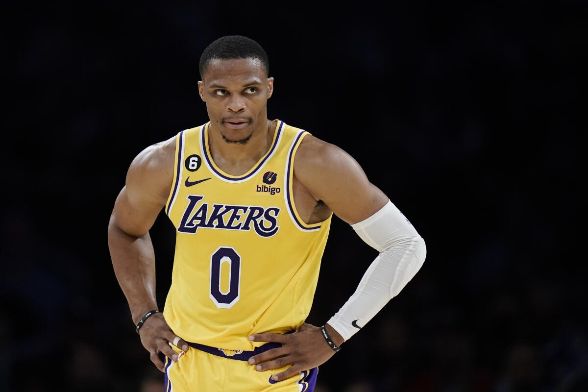 Lakers guard Russell Westbrook stands on the court with his hands on his hips.