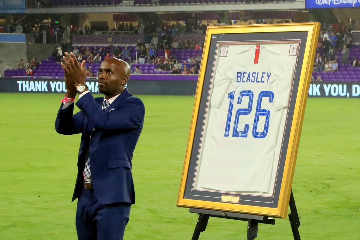 DaMarcus Beasley is honored before a match between the United States and Canada on Nov. 15 in Orlando, Fla. In his career, he has been the target of racial slurs in European stadiums.  “It’s so hard to act like you don’t hear it,” he says.
