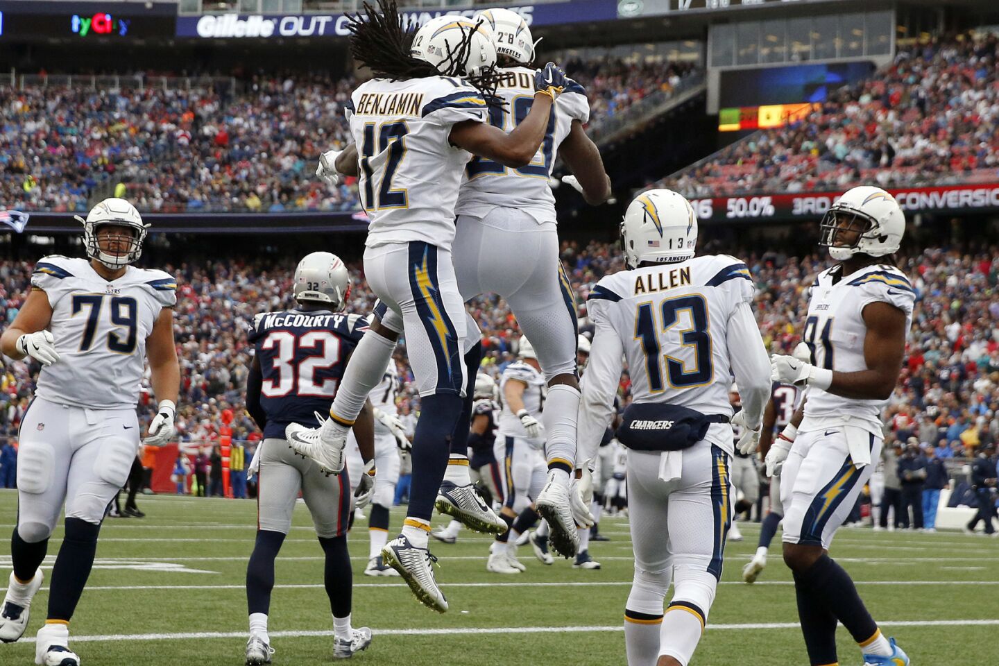 Chargers wide receiver Travis Benjamin leaps to celebrates his touchdown catch with Melvin Gordon during the second half.