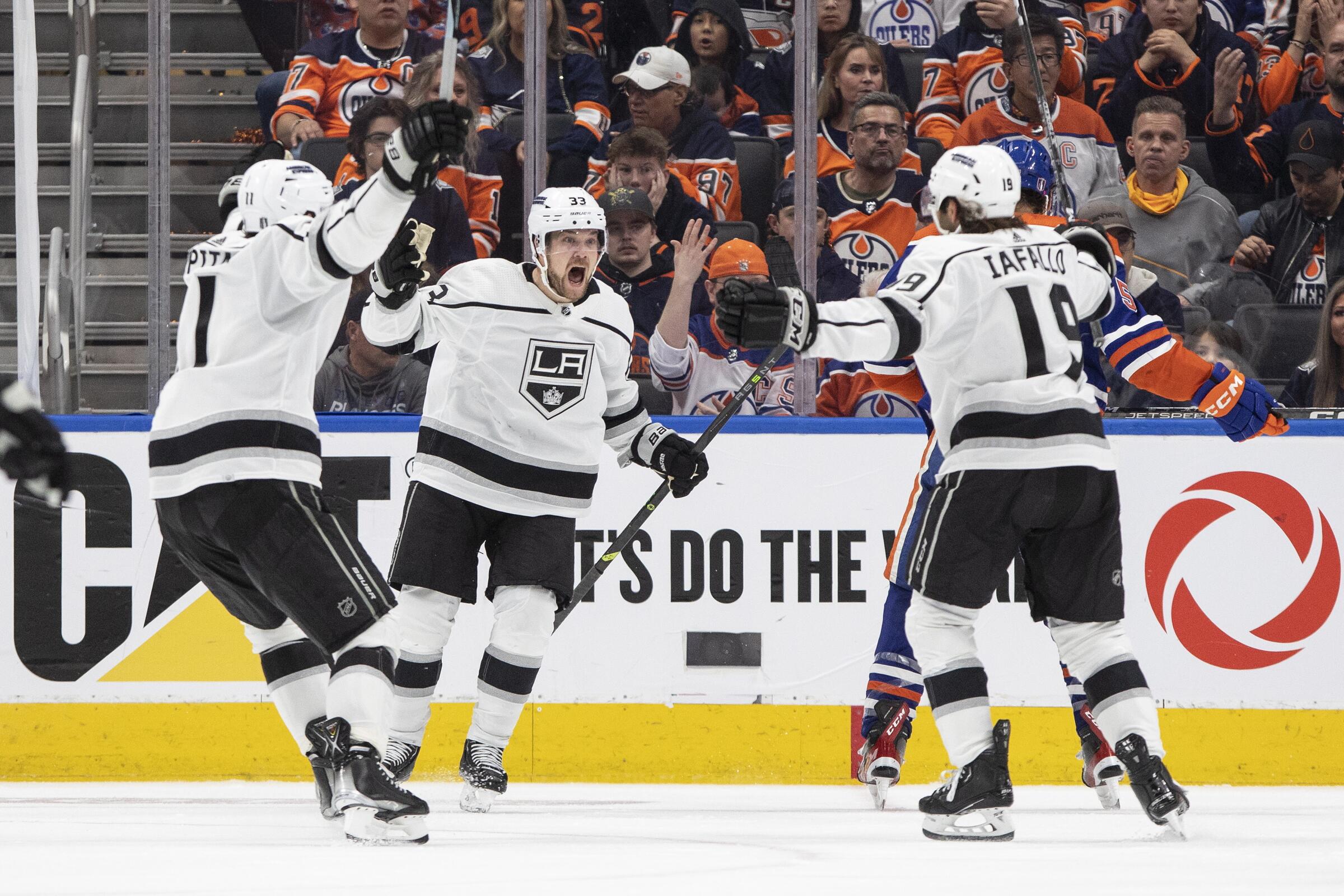 Kings forward Alex Iafallo (19) celebrates with teammates after scoring in overtime in a 4-3 win over the Edmonton Oilers.