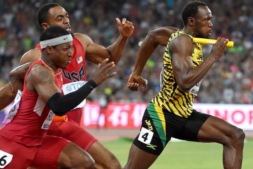 Usain Bolt (4) anchors Jamaica's winning 400-meter relay team as Americans Mike Rodgers (6) and Tyson Gay make an illegal exchange outside the passing zone at the IAAF World Championships on Saturday.