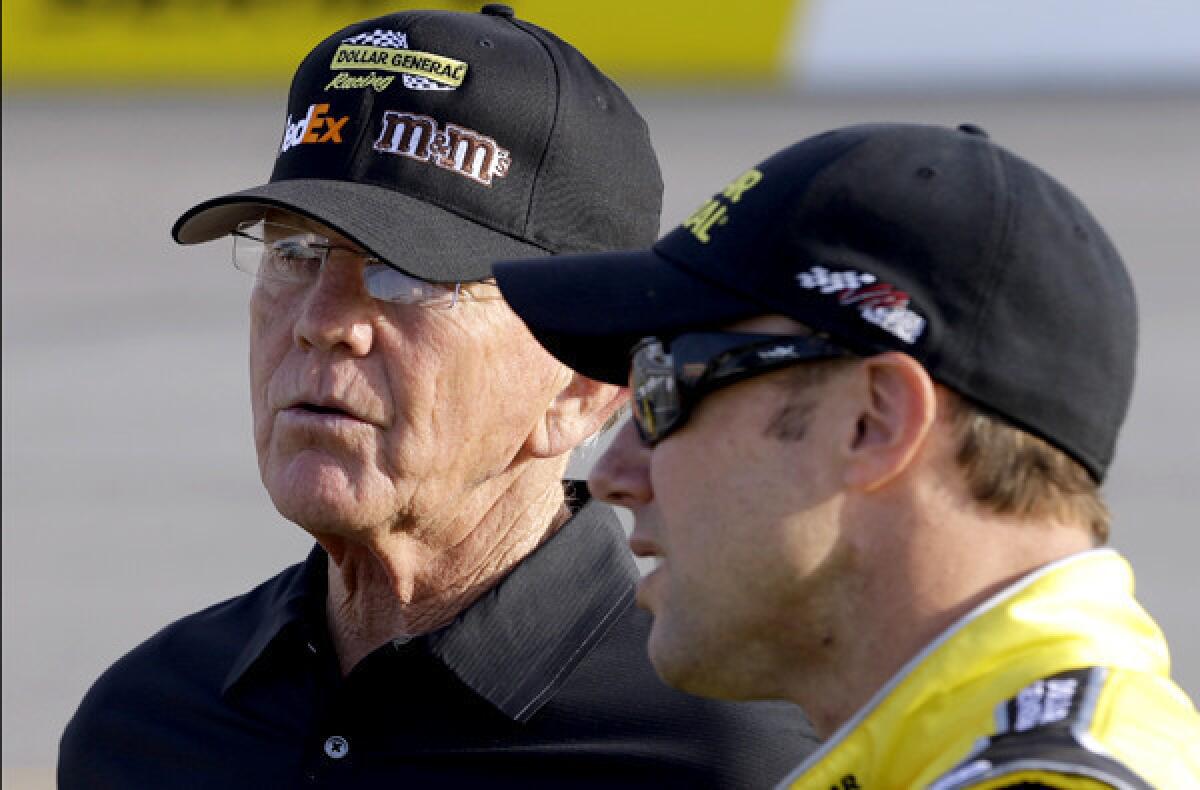 NASCAR team owner Joe Gibbs, left, talks with driver Matt Kenseth during qualifying for the Sprint Cup Series race at Richmond International Raceway last month.