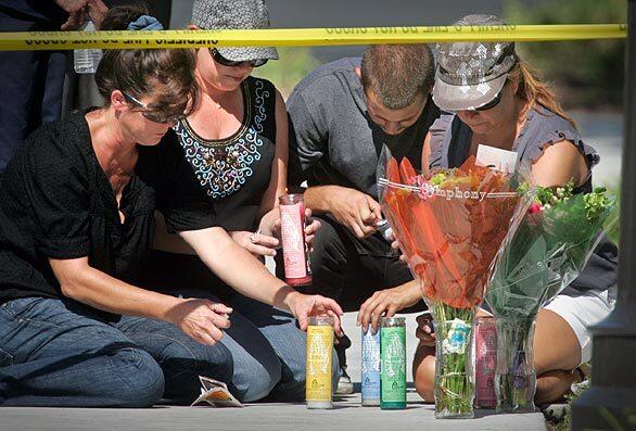 From left, Debbie, Donna, Erik and Silvia Krecu light candles and place flowers outside a San Clemente condo where their friend was found badly beaten; she later died. John Wylie Needham, 25, the victim's boyfriend and an Army veteran, has been arrested in connection with the slaying.
