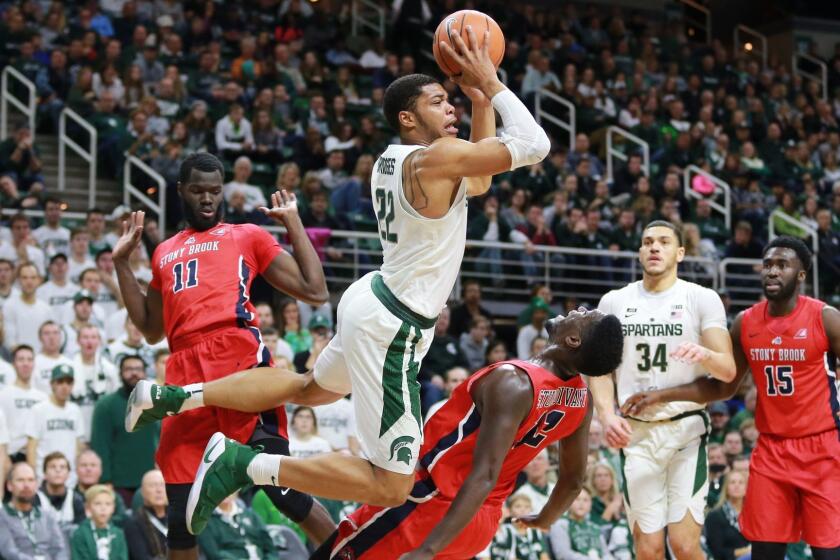 EAST LANSING, MI - NOVEMBER 19: Miles Bridges #22 of the Michigan State Spartans draws a blocking foul from Tyrell Sturdivant of the Stony Brook Seawolves at Breslin Center on November 19, 2017 in East Lansing, Michigan. (Photo by Rey Del Rio/Getty Images) ** OUTS - ELSENT, FPG, CM - OUTS * NM, PH, VA if sourced by CT, LA or MoD **