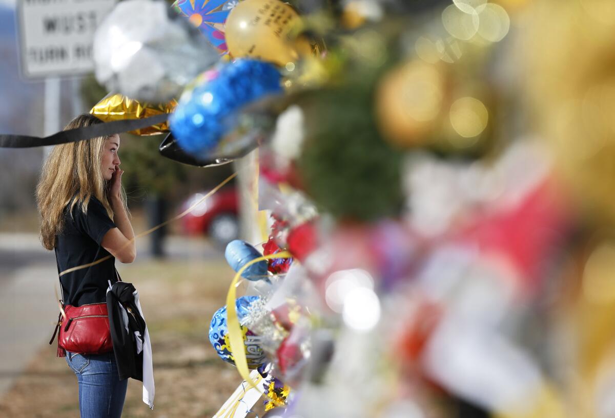 Arapahoe High School student Vice President Grace Marlowe visits a tribute site for Claire Davis in Centennial, Colo. Davis died Saturday afternoon, hospital officials said.