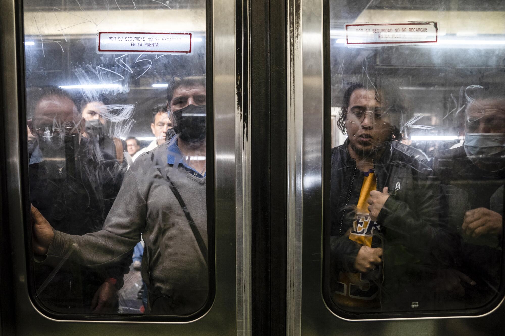 People stand before a window door.