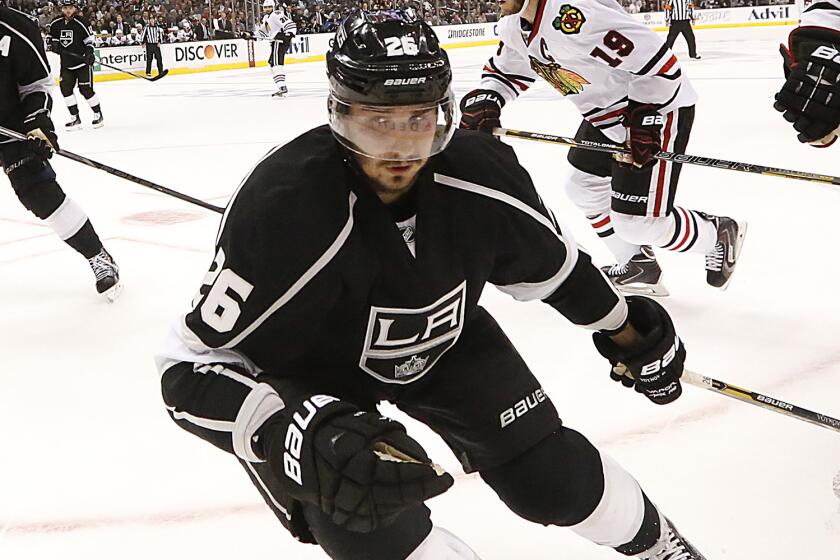 Kings defenseman Slava Voynov chases down a loose puck during a May 26 Western Conference finals game against the Chicago Blackhawks.