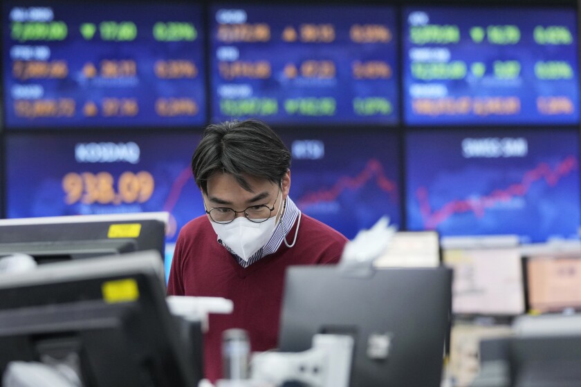 A currency trader watches monitors at the foreign exchange dealing room of the KEB Hana Bank headquarters in Seoul, South Korea, Thursday, Jan. 20, 2022. Asian stock markets rose Thursday after China cut interest rates to shore up flagging economic growth and Japan reported a double-digit rise in exports. (AP Photo/Ahn Young-joon)