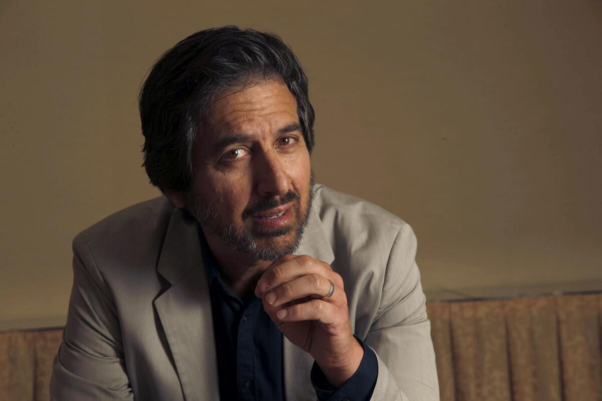 Ray Romano leans forward and gestures with one hand