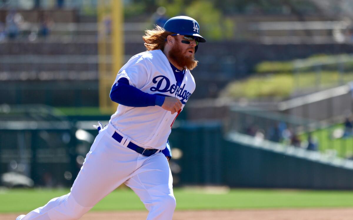 Dodgers third baseman Justin Turner rounds third base during a spring training game against the White Sox on Feb. 25.