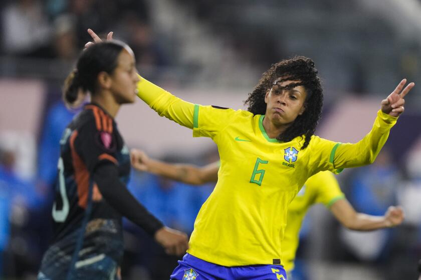 Brazil defender Yasmim, right, celebrates her goal, near Argentina midfielder Dalila Ippolito, during the first half of a CONCACAF Gold Cup women's soccer tournament quarterfinal Saturday, March 2, 2024, in Los Angeles. (AP Photo/Ryan Sun)