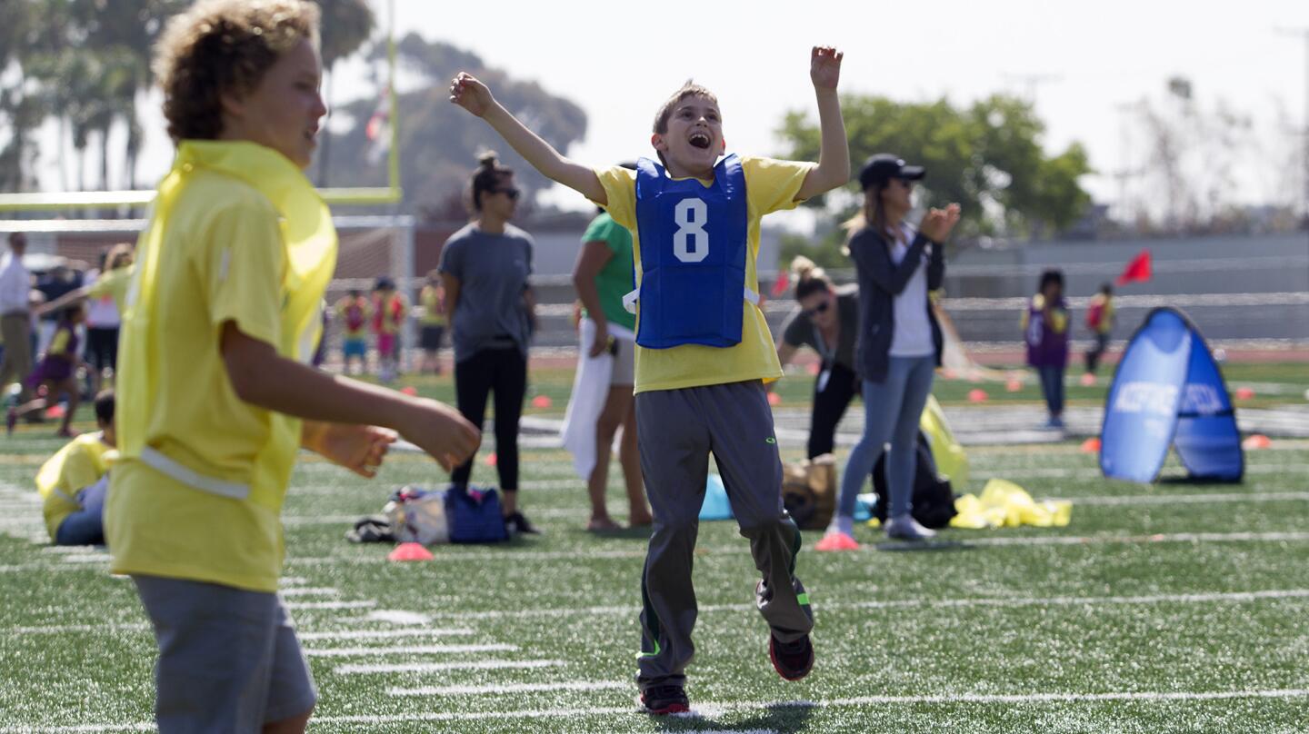 Justin Halloran (8), a fifth-grader from Adams Elementary School, cheers after scoring a goal against Eastbluff during a Special Olympics of Southern California soccer match at Mustang Field in Costa Mesa on Monday.