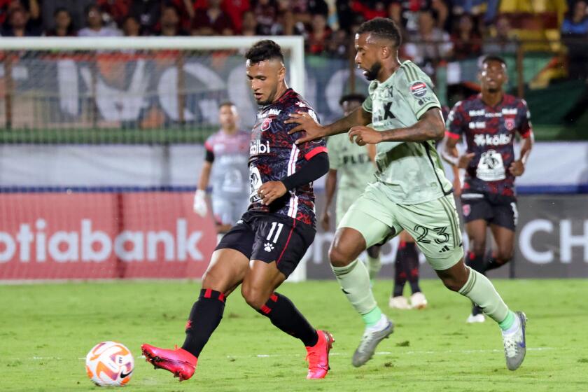 Alajuelense Sports League's (LDA) Alexander Lopez (L) goes for the ball against Los Angeles Futbol Club's (LAFC) Kellyn Acosta (R) during the Champions League match of the Concacaf 2023 at the Alejandro Morera Soto stadium in Alajuela, Costa Rica, March 9, 2023. (Photo by Randall CAMPOS / AFP) (Photo by RANDALL CAMPOS/AFP via Getty Images)