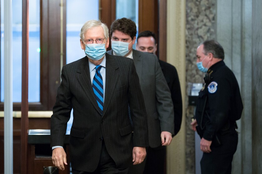 Senate Majority Leader Mitch McConnell and others pass through security at the U.S. Capitol on New Year's Day.