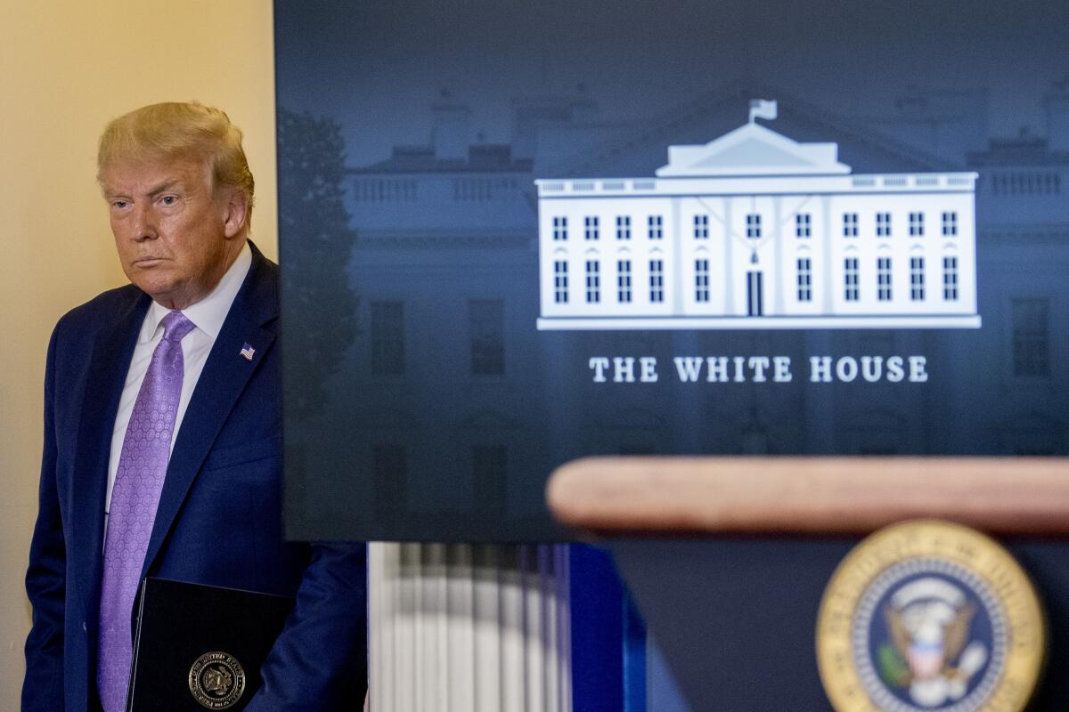 President Trump enters the White House press briefing room on Aug. 5. 