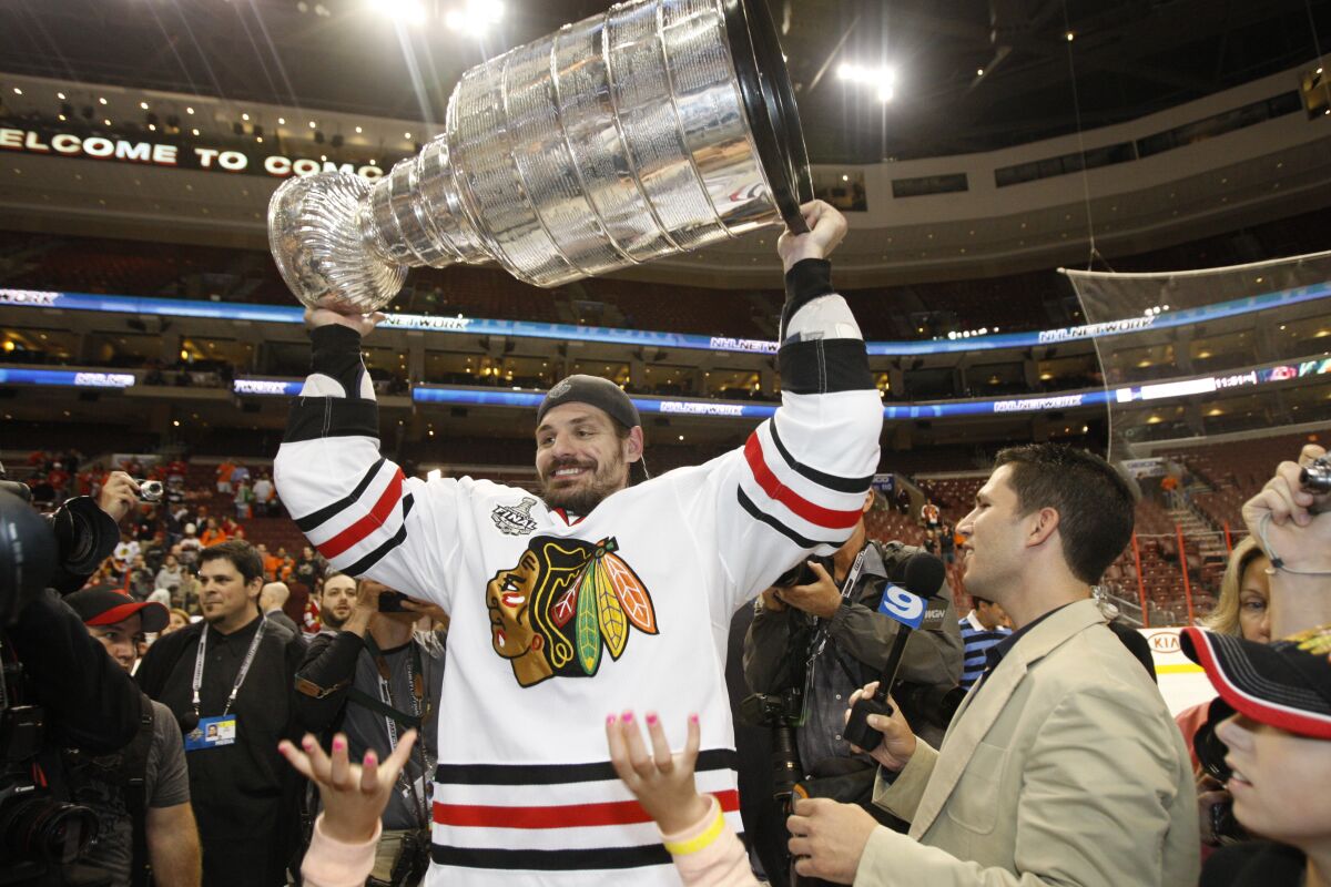 FILE - In this June 9, 2010, file photo, Chicago Blackhawks defenseman Brent Sopel lifts the Stanley Cup after the Blackhawks beat the Philadelphia Flyers 4-3 in overtime to win Game 6 of the NHL Stanley Cup hockey finals in Philadelphia. The former NHL defenseman is drawing upon the lifelong challenges he faced in dealing with dyslexia to help others(AP Photo/Kathy Willens, File)