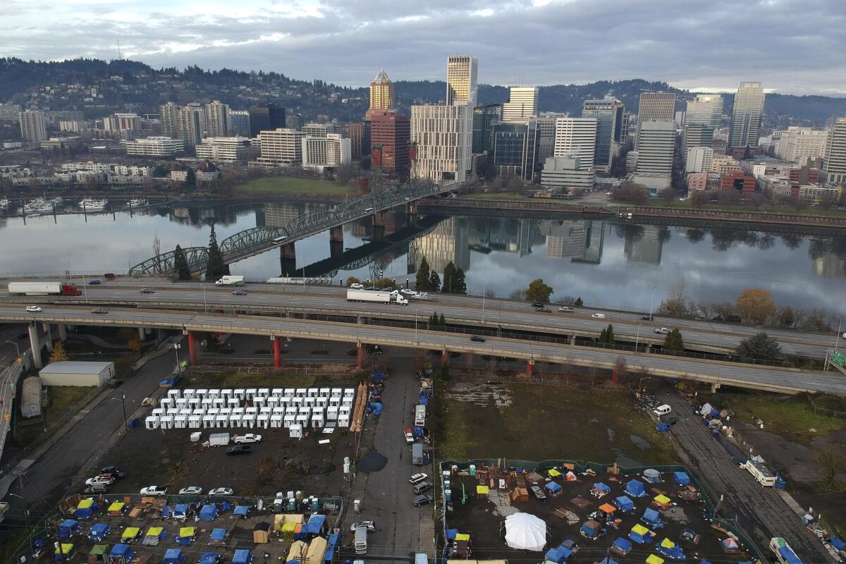 Tents set up in a parking lot for people experiencing homelessness