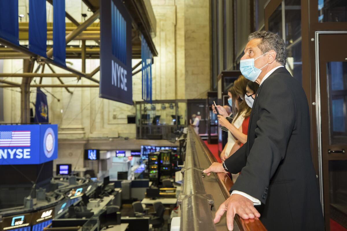 New York Gov. Andrew Cuomo looks over the trading floor at the New York Stock Exchange, which reopened with social distancing guidelines on Tuesday.