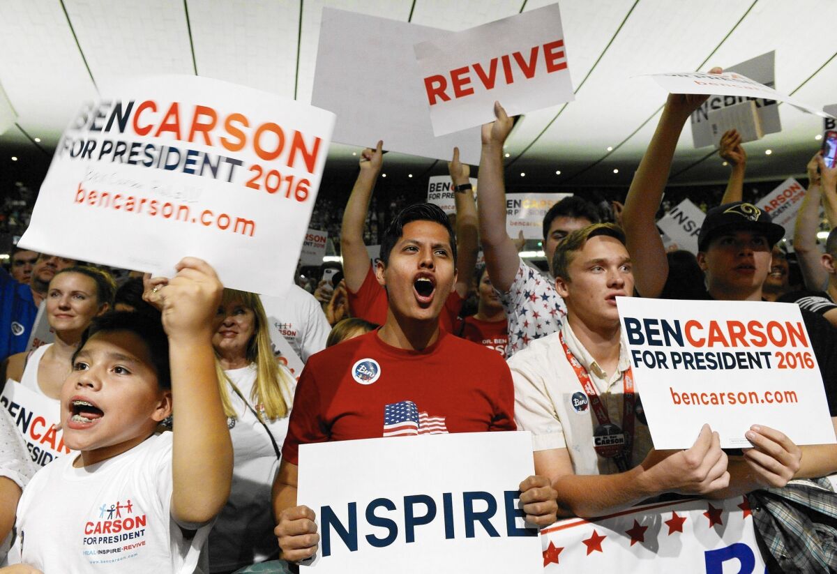 Supporters of GOP presidential candidate Ben Carson cheer during a campaign rally at the Anaheim Convention Center.
