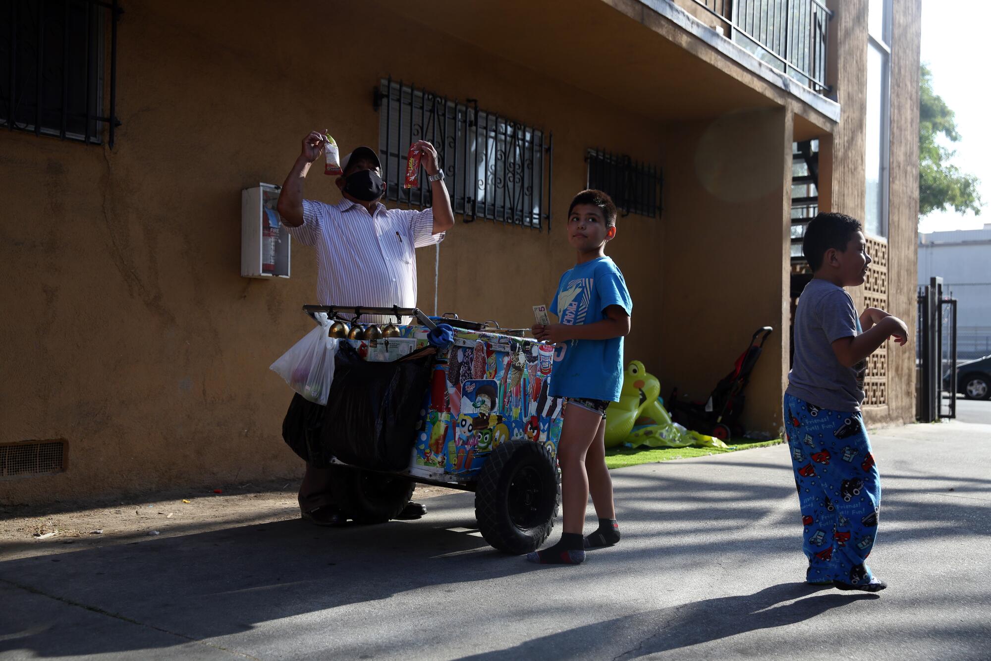 Rios sells paletas to children in an apartment complex.