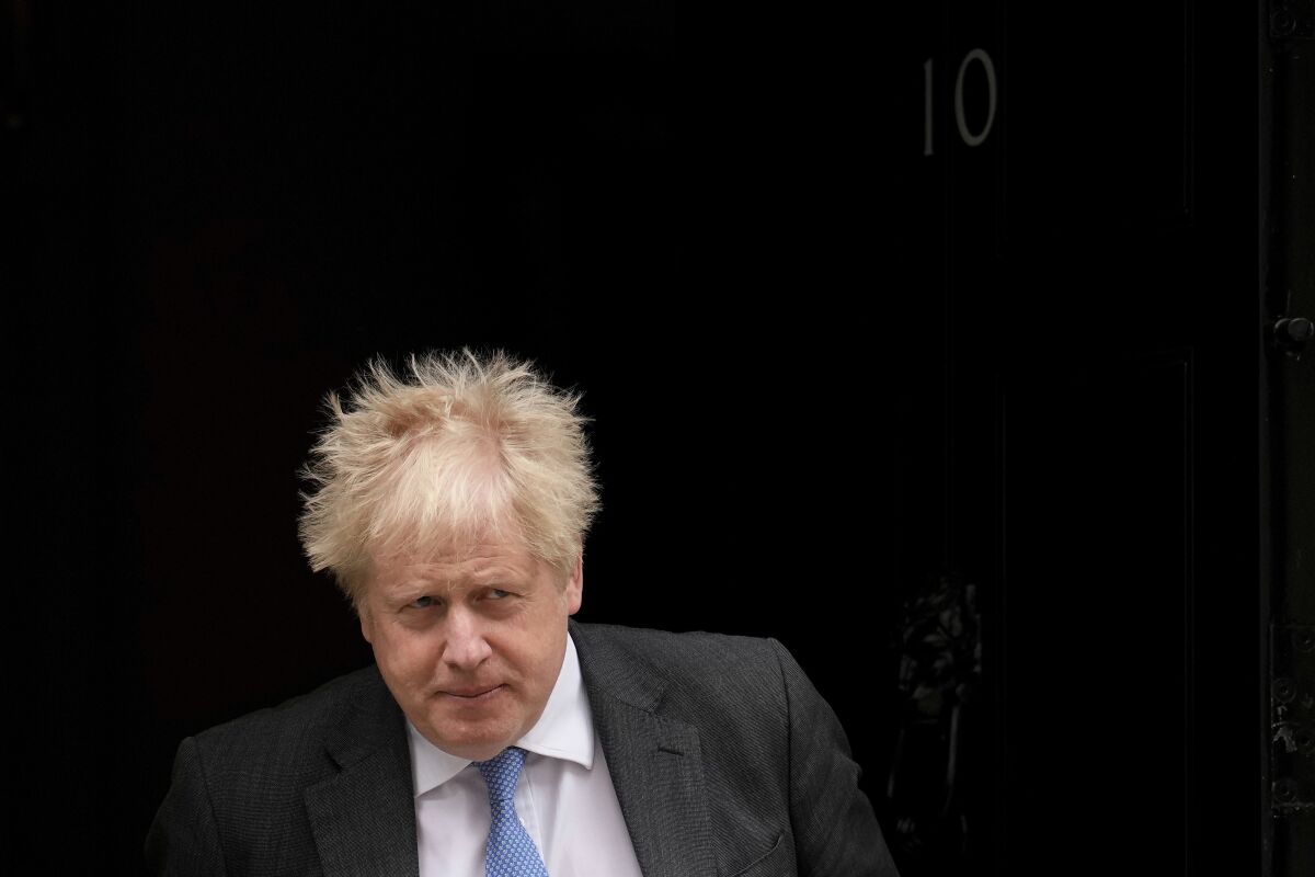 FILE - British Prime Minister Boris Johnson leaves 10 Downing Street to attend the weekly Prime Minister's Questions at the Houses of Parliament, in London, Wednesday, April 27, 2022. When British Prime Minister Boris Johnson survived a no-confidence vote this week, at least one other world leader shared his relief. Ukrainian President Volodymyr Zelenskyy said it was “great news” that “we have not lost a very important ally.” It was a welcome endorsement for a British leader who divides his country, and his party, but has won wide praise as an ally of Ukraine. (AP Photo/Matt Dunham, File)