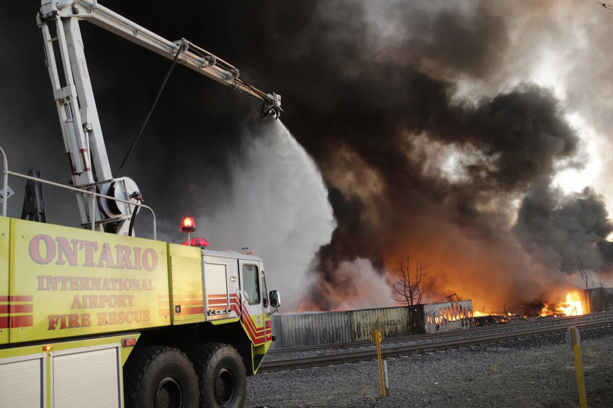 Ontario International Airport fire crews battle the fast-moving fire at a recycling center.