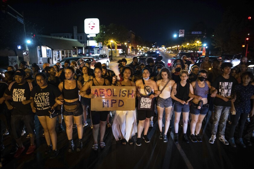 Dozens of community members march, Sunday, June 6, 2021, in Minneapolis, for Winston Boogie Smith Jr., who was fatally shot by members of a U.S. Marshals task force several days earlier. (AP Photo/Christian Monterrosa)