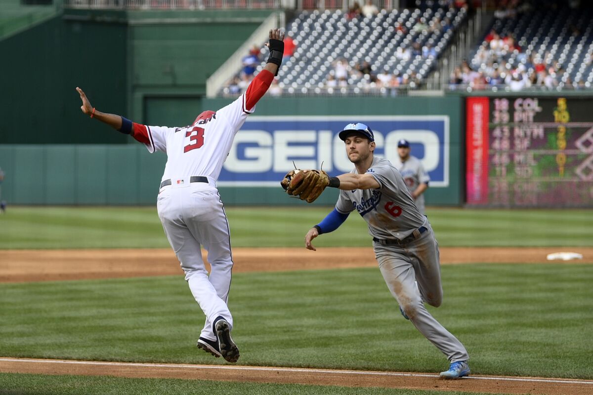 Dodgers shortstop Trea Turner chases Washington Nationals' Alcides Escobar during a rundown on a single.