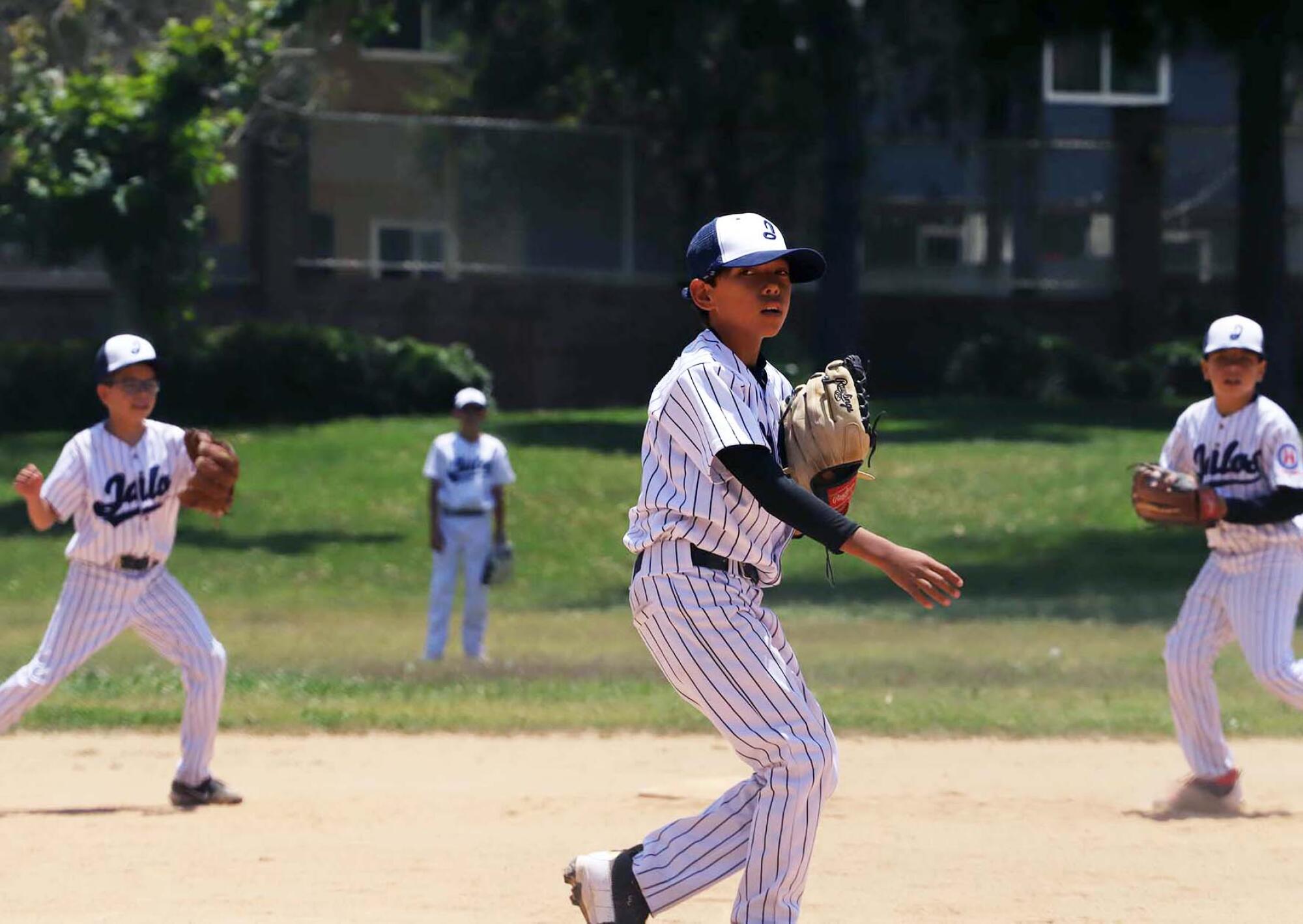 Youth baseball player throws a pitch
