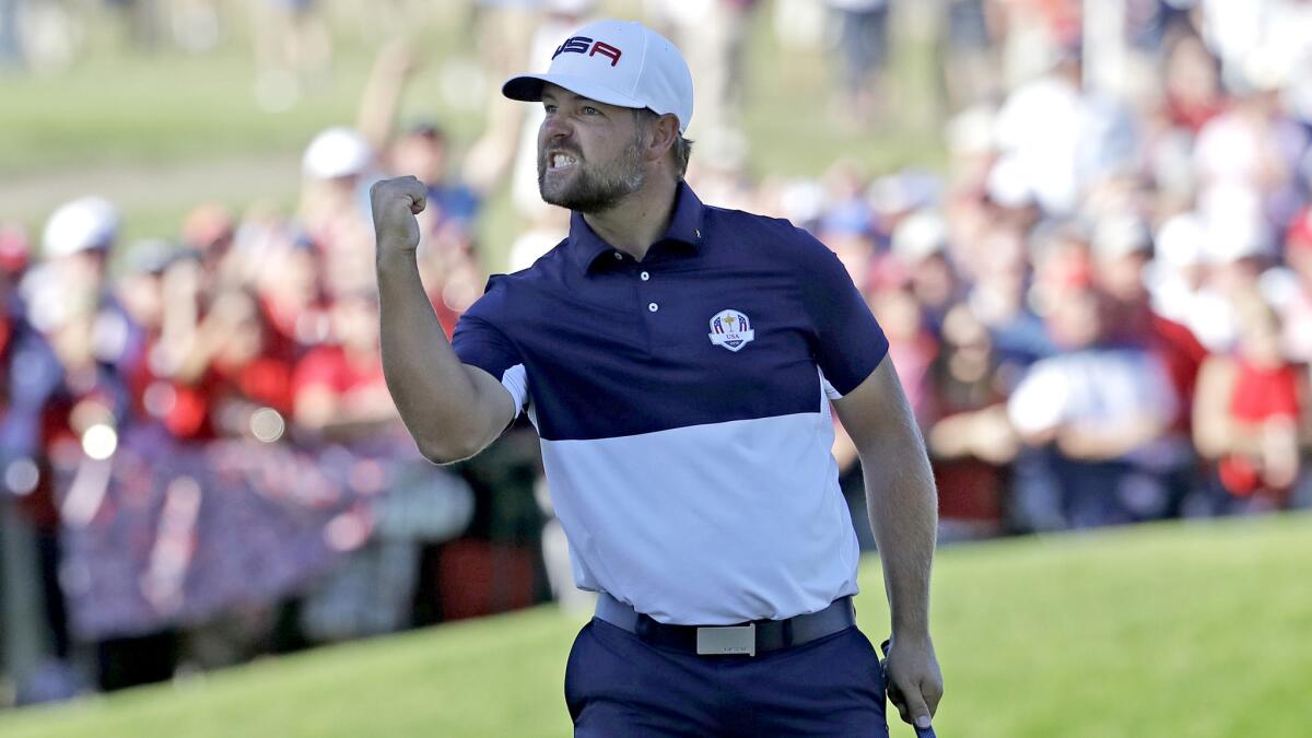 American Ryan Moore exults after clinching his singles match for the point that defeated Europe on Sunday.