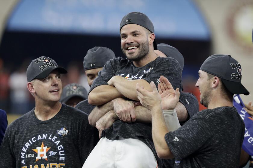 Houston Astros second baseman Jose Altuve is held up after they won Game 6 of baseball's American League Championship Series against the New York Yankees Saturday, Oct. 19, 2019, in Houston. The Astros won 6-4 to win the series 4-2. (AP Photo/Eric Gay)