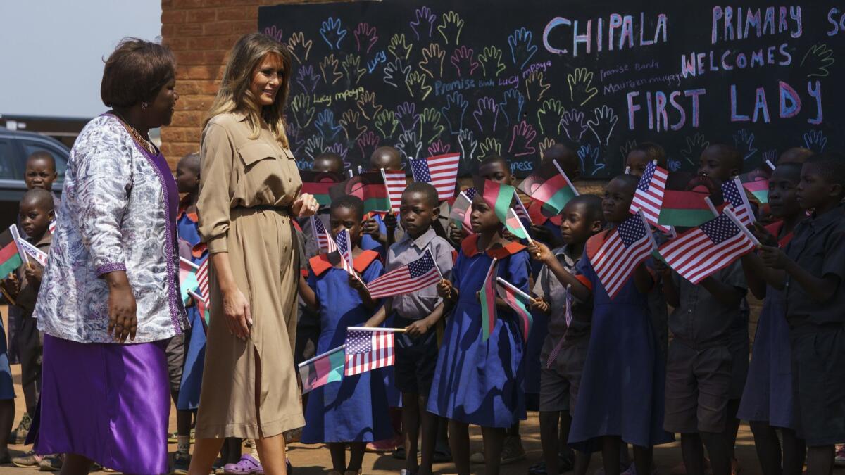 First Lady Melania Trump is escorted by head teacher Maureen Masi as she arrives for a visit to Chipala Primary School in Lilongwe, Malawi, on Thursday.