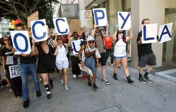 Protesters march along 7th Street in downtown Los Angeles on the one-year anniversary of the Occupy Los Angeles movement.