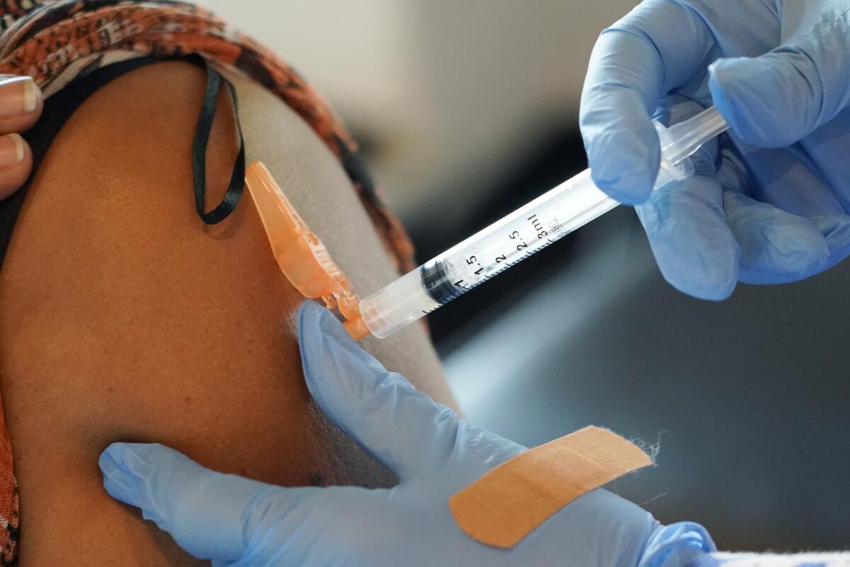 A nurse administers a dose of COVID-19 vaccine at Jackson-Hinds Comprehensive Health Center in Jackson, Miss.