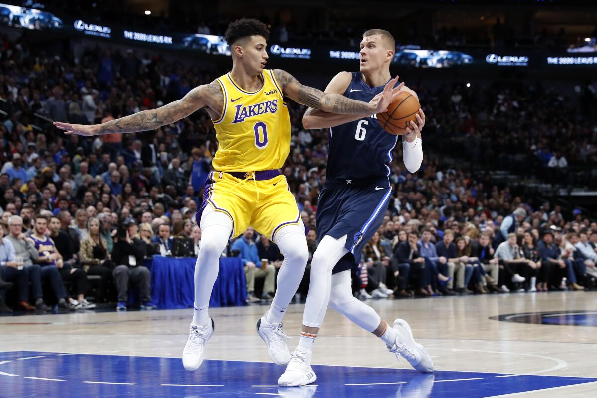 Lakers forward Kyle Kuzma defends Mavericks forward Kristaps Porzingis (6) as he drives to the basket during the second half of a game Nov. 1.