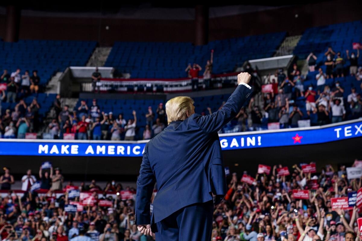 President Donald Trump arrives on stage to speak at Saturday's campaign rally at the BOK Center in Tulsa, Okla.