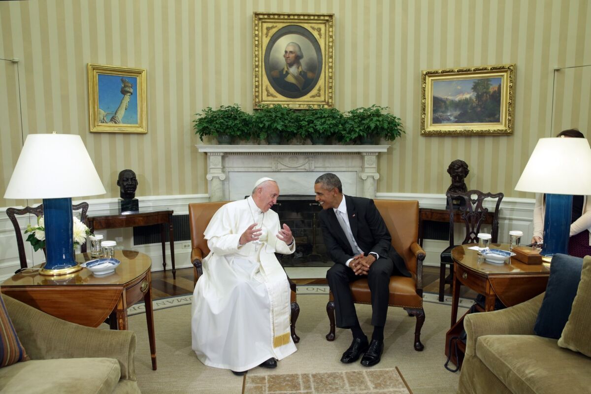 Pope Francis and President Obama talk in the Oval Office during the arrival ceremony at the White House.