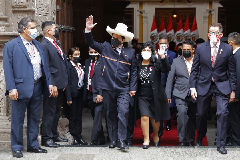 FILE - Peru's then-President-elect Pedro Castillo and his wife Lilia Paredes wave as they leave the Foreign Ministry to go to Congress for his swearing-in ceremony on his Inauguration Day in Lima, Peru, Wednesday, July 28, 2021. Peru´s prosecutor's office announced on Thursday, May 5, 2022, that is investigating President Castillo and Paredes for aggravated plagiarism after a local television station reported that the master´s thesis that the couple co-authored was at least partially plagiarized. (AP Photo/Guadalupe Pardo, File)