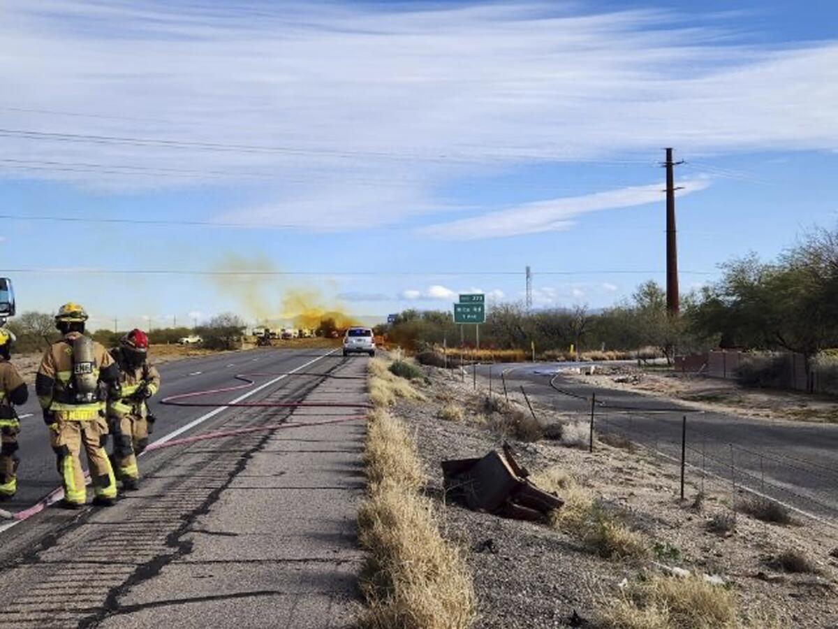 Stretch of interstate highway near Tucson, with smoke visible in the distance