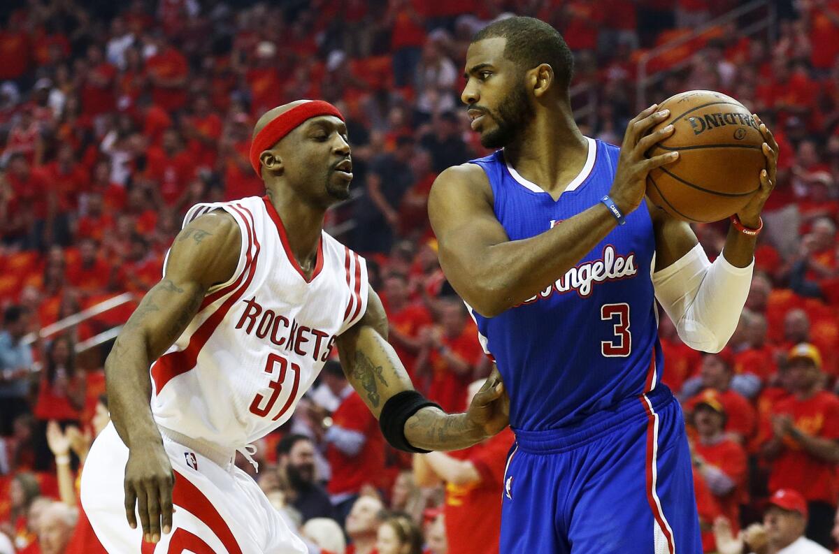 Clippers point guard Chris Paul protects the ball from Rockets guard Jason Terry in the first half of Game 7 on Sunday in Houston.