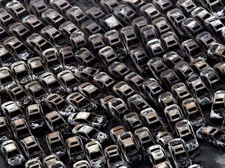 An aerial view shows a mass of cars burned by fires in Sendai on March 14. The earthquake and tsunami damage could have a profound effect on Japans production sites and economic institutions.