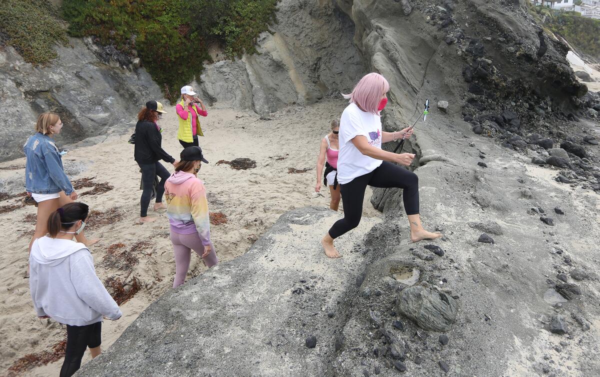 Sharael Kolberg of Laguna Beach, hikes over beach rocks.