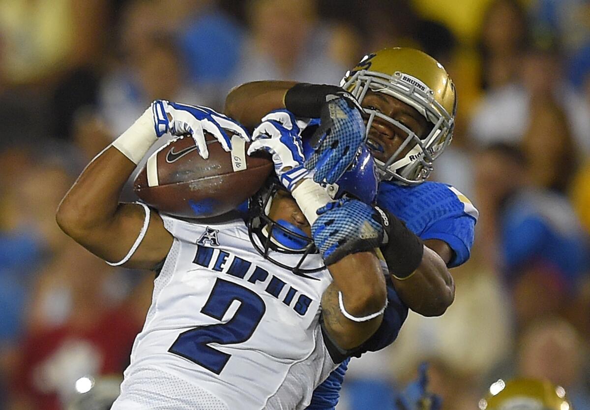 UCLA's Fabian Moreau goes for the tackle after a catch by Memphis' Joe Craig on Sept. 6.