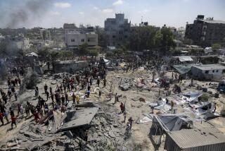 FILE -Palestinians inspect the damage at a site hit by an Israeli bombardment on Khan Younis, southern Gaza Strip, Saturday, July 13, 2024. Israel said it targeted Hamas' shadowy military commander Mohammed Deif in a massive strike Saturday in the crowded southern Gaza Strip that killed at least 71 people, according to local health officials. (AP Photo/Jehad Alshrafi, File)