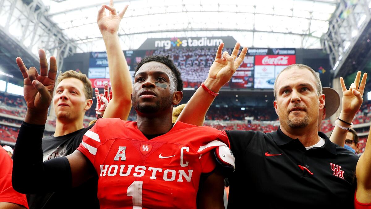 Houston Coach Tom Herman, right, and quarterback Greg Ward Jr. (1) celebrate their victory over Oklahoma on Saturday.