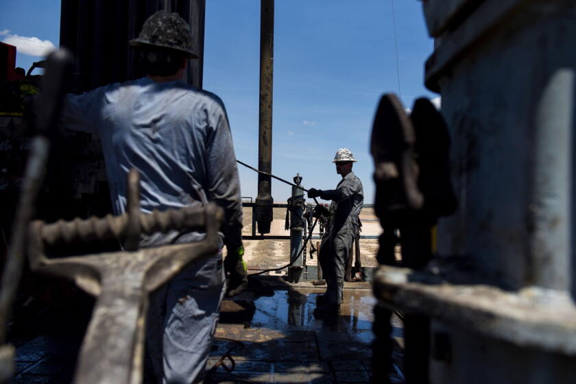 Contractors operate a drilling pipe at an oil rig in Reeves County, Texas. Photographer: Callaghan O'Hare/Bloomberg