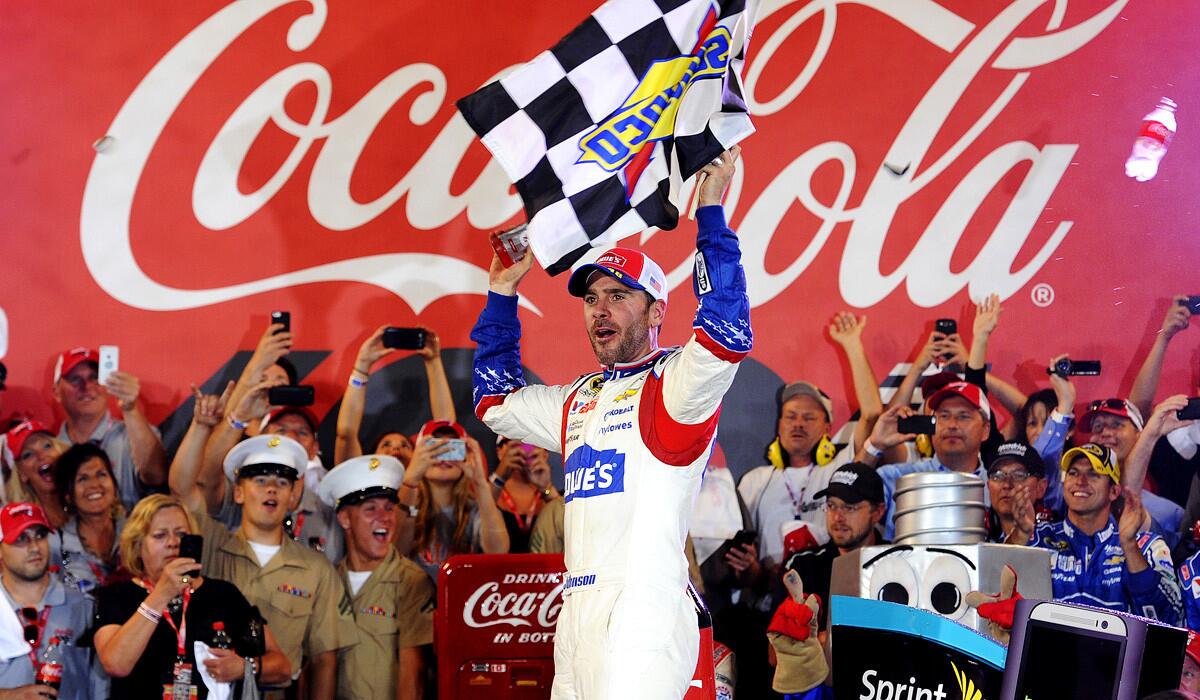 Jimmie Johnson celebrates in Victory Lane after winning the NASCAR Sprint Cup Series Coca-Cola 600 at Charlotte Motor Speedway on Sunday.