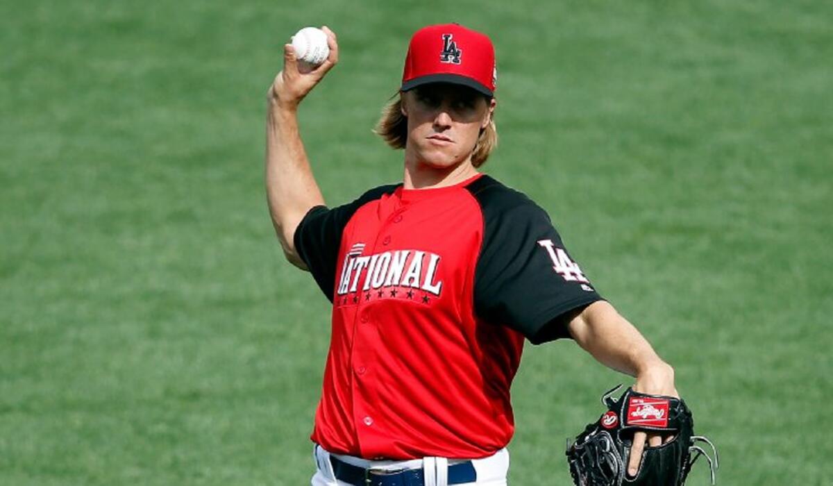 National League All-Star Game starter Zack Greinke tosses during a workout on Monday.