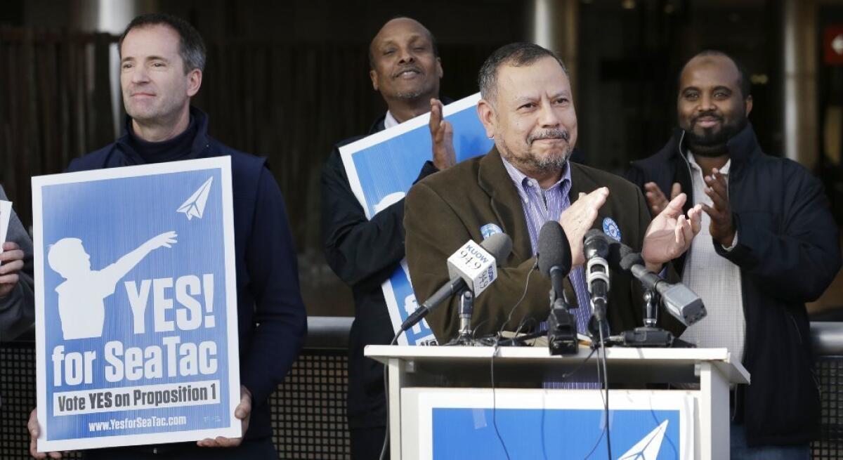 Supporters of SeaTac's minimum wage measure celebrate its narrow victory.