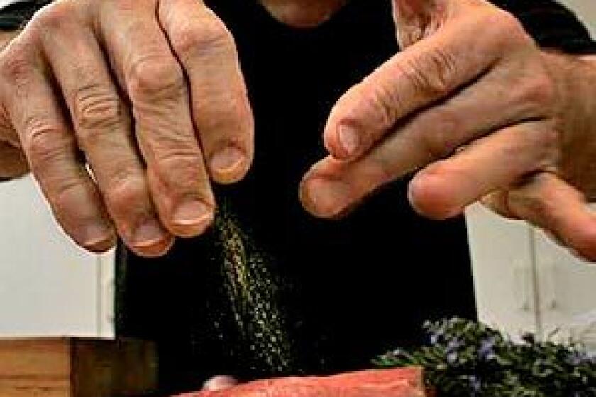 AT WORK: Dario Cecchini hovers over spalla di maiale  pork steaks cut from the butt, seasoned with fennel pollen, sautéed in olive oil and served on Tuscan kale.